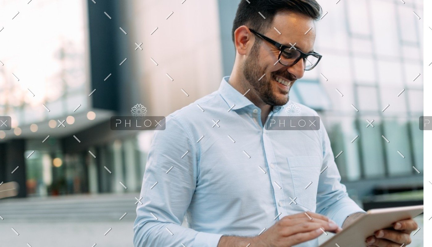 demo-attachment-609-portrait-of-businessman-in-glasses-holding-tablet-AWVHCJU